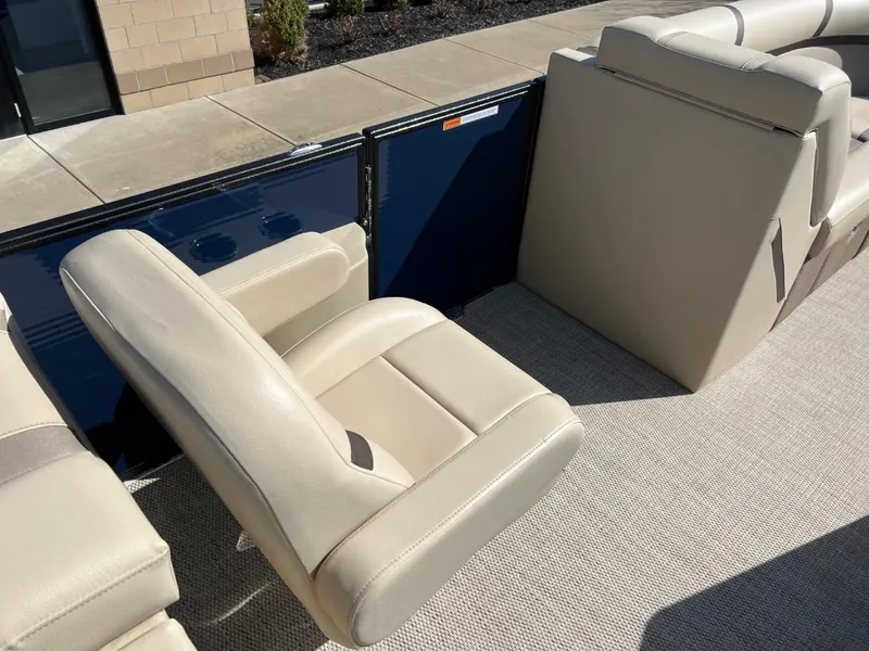 Slide: The Image of 2024 Crest Classic LX 220 boat interior with beige seating and carpet flooring. - 8