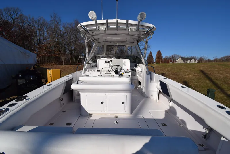 Slide: The Image of 2005 Donzi 38 ZSF boat interior with helm, seating, and clear blue sky. - 10