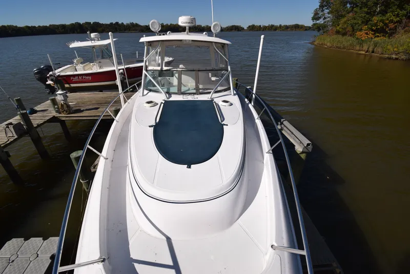 Slide: The Image of 2005 Donzi 38 ZSF boat docked on a calm lake with clear skies. - 13