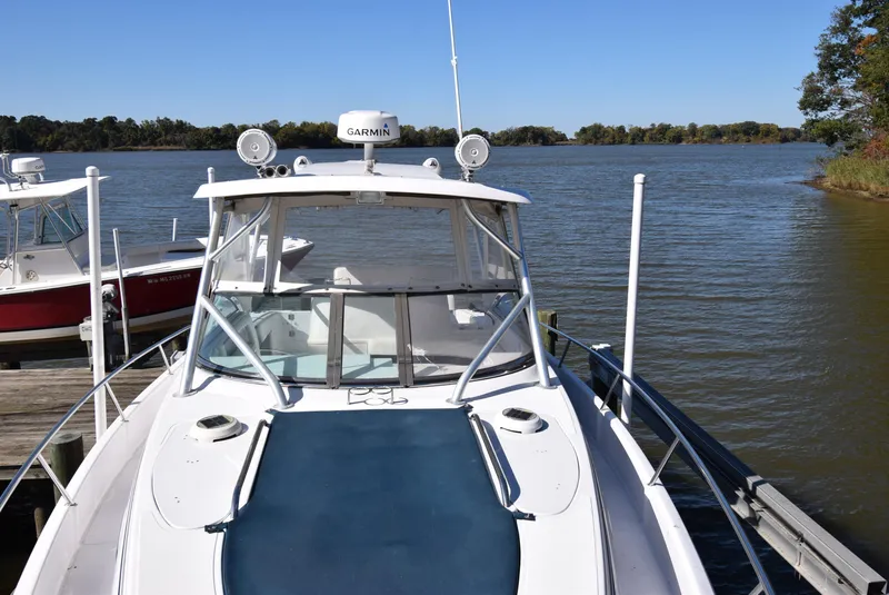 Slide: The Image of 2005 Donzi 38 ZSF boat docked on a calm lake with clear blue skies. - 15