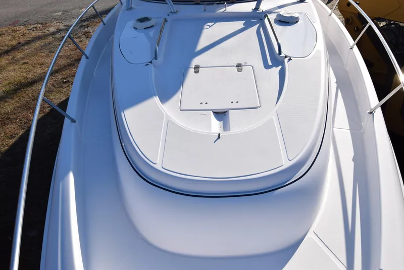 Slide: The Image of 2005 Donzi 38 ZSF boat deck, white surface with railings and hatches. - 17