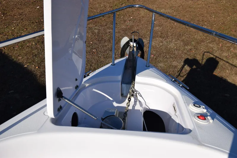 Slide: The Image of 2005 Donzi 38 ZSF boat anchor compartment with open hatch and chain mechanism. - 18