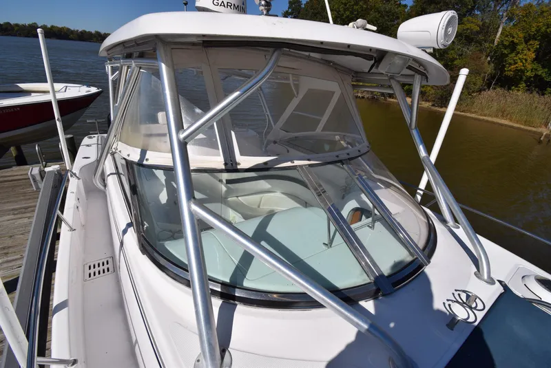 Slide: The Image of 2005 Donzi 38 ZSF boat docked by the water, featuring a sleek design and sturdy frame. - 19