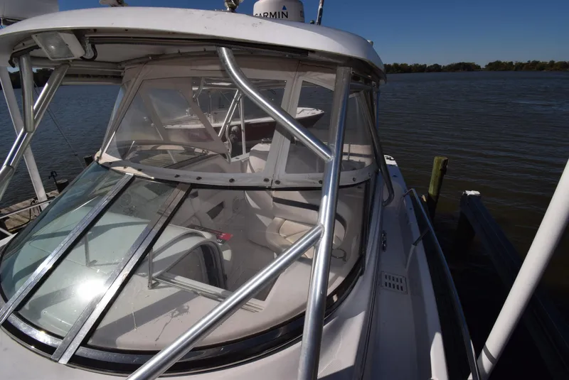 Slide: The Image of 2005 Donzi 38 ZSF boat docked by the water on a sunny day. - 20