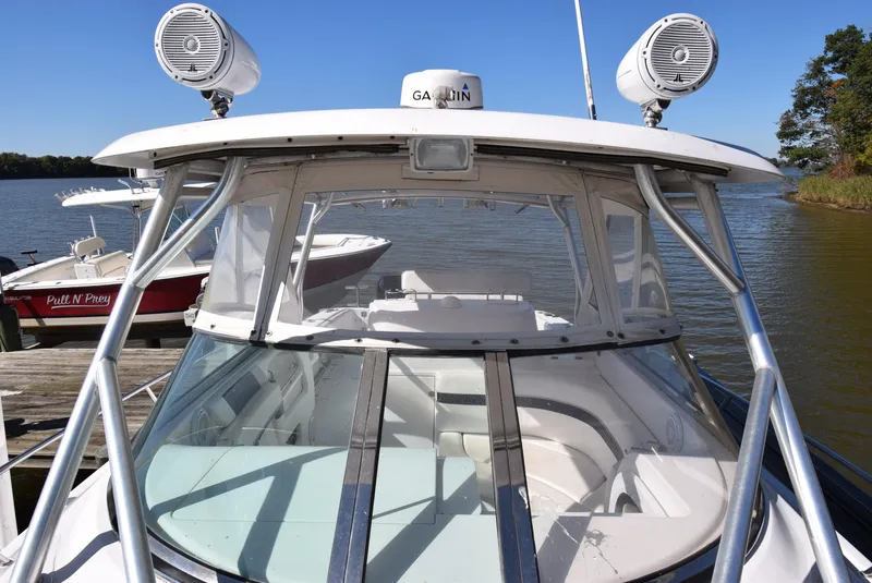 Slide: The Image of 2005 Donzi 38 ZSF boat docked on a sunny day, featuring a sleek design and modern equipment. - 21