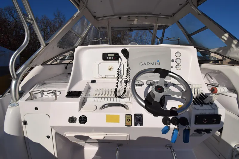 Slide: The Image of 2005 Donzi 38 ZSF boat cockpit with Garmin navigation system and steering wheel. - 23