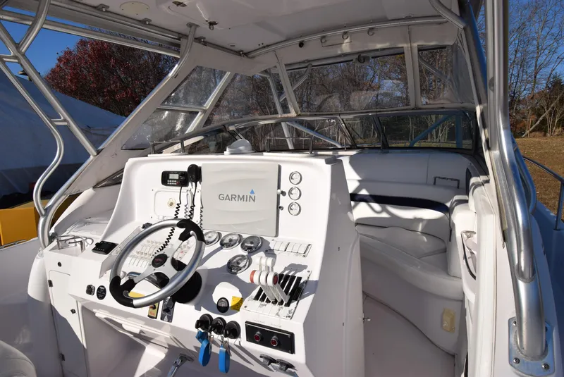 Slide: The Image of 2005 Donzi 38 ZSF boat cockpit with Garmin navigation system and steering wheel. - 24