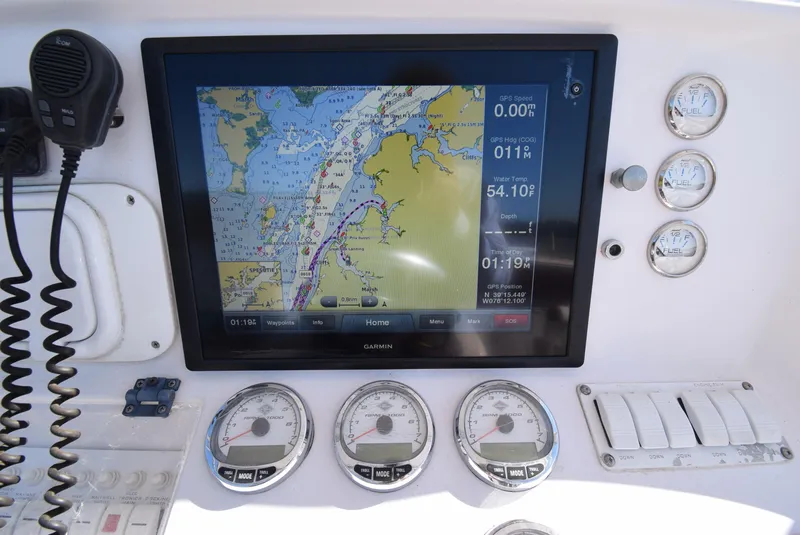 Slide: The Image of Dashboard of a 2005 Donzi 38 ZSF boat with navigation and fuel gauges. - 26