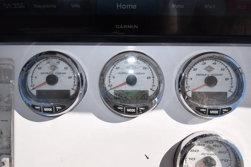 Slide: The Image of Dashboard of a 2005 Donzi 38 ZSF boat with RPM gauges and Garmin display. - 27