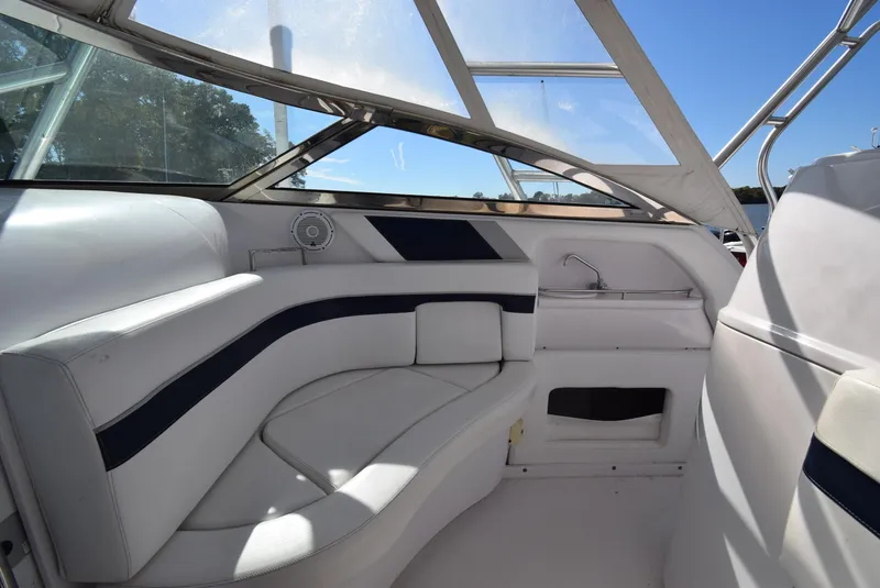 Slide: The Image of Interior of a 2005 Donzi 38 ZSF boat with white seating and blue accents. - 31