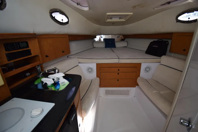 Slide: The Image of Interior of 2005 Donzi 38 ZSF boat with cozy seating and compact kitchenette. - 36