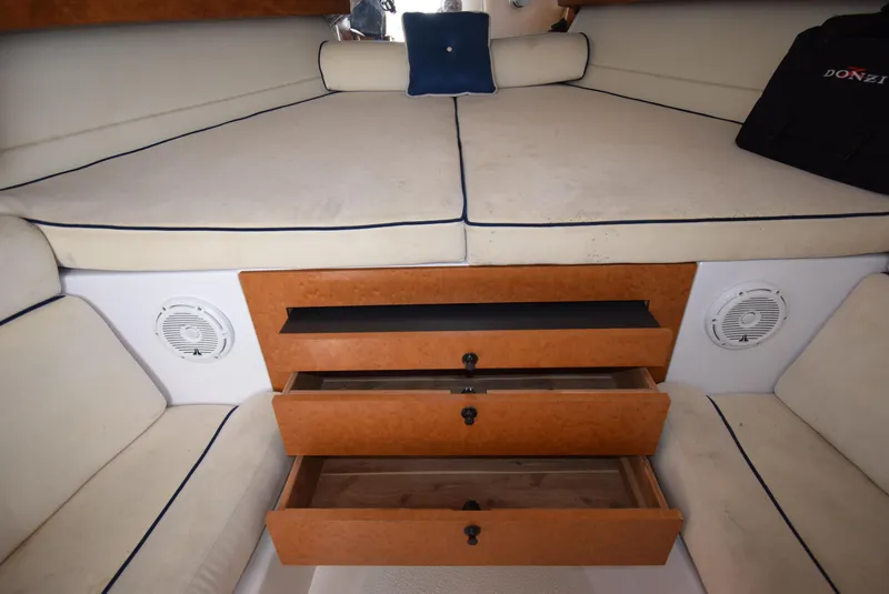 Slide: The Image of Interior cabin of 2005 Donzi 38 ZSF boat with storage drawers and cushioned seating. - 38