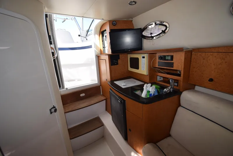 Slide: The Image of Interior of 2005 Donzi 38 ZSF boat with kitchenette, TV, and seating area. - 39
