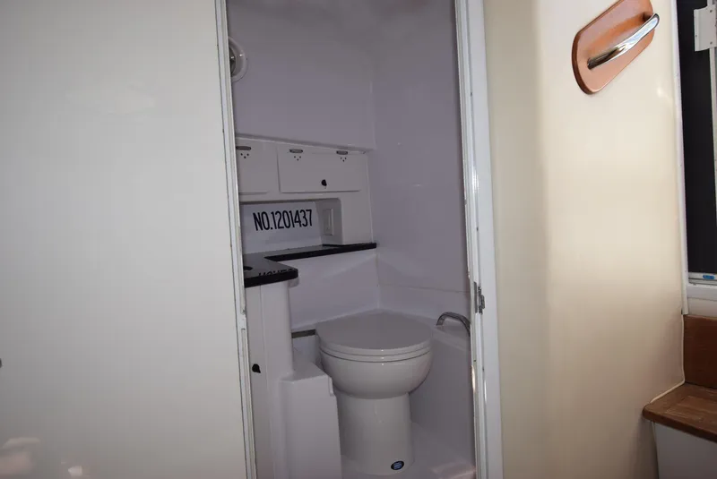 Slide: The Image of 2005 Donzi 38 ZSF boat bathroom interior with toilet and storage cabinets. - 42
