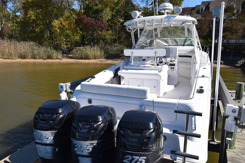 Slide: The Image of 2005 Donzi 38 ZSF boat with triple 275 engines docked by a scenic shoreline. - 7