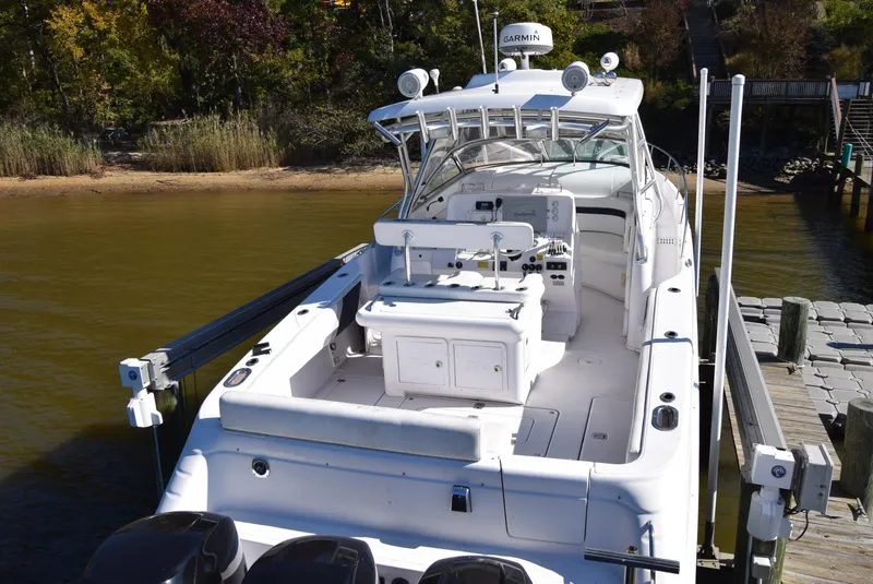 Slide: The Image of 2005 Donzi 38 ZSF boat docked, featuring spacious deck and modern equipment. - 8