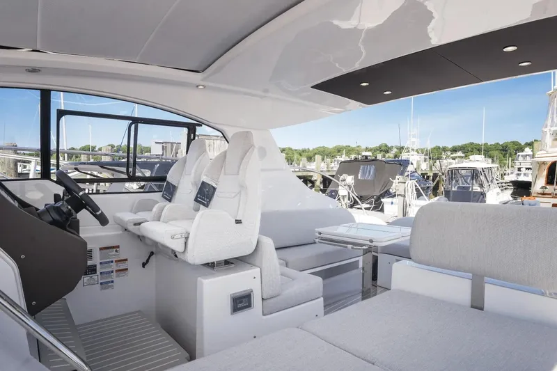 Slide: The Image of 2026 Azimut Atlantis 45 yacht interior with modern seating and helm, docked at marina. - 17