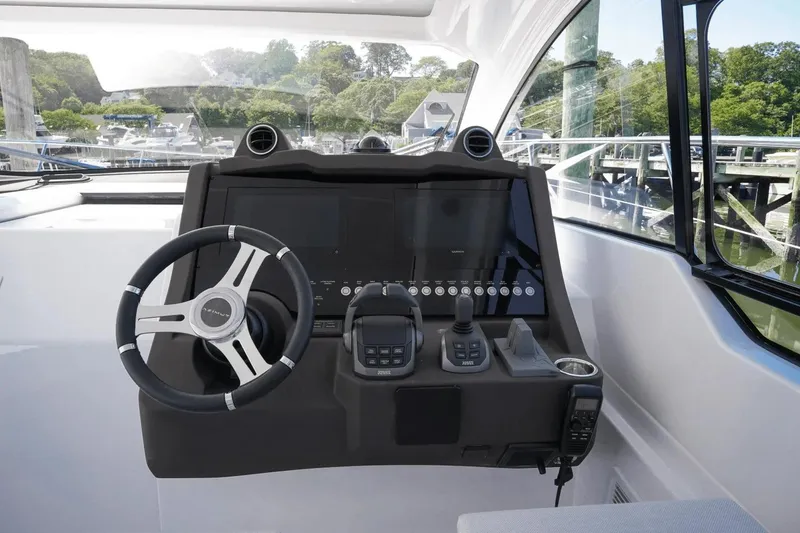 Slide: The Image of Helm of 2026 Azimut Atlantis 45 yacht with modern controls and steering wheel. - 20