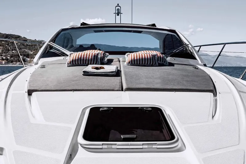 Slide: The Image of 2026 Azimut Atlantis 45 yacht with sunbathing area and striped cushions on deck. - 23