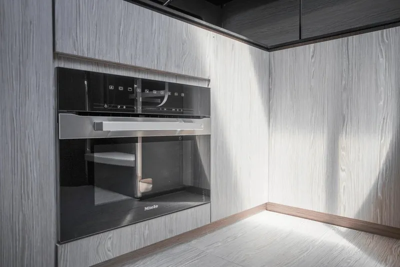 Slide: The Image of Modern kitchen interior in 2026 Azimut Atlantis 45 yacht, featuring sleek Miele oven. - 28