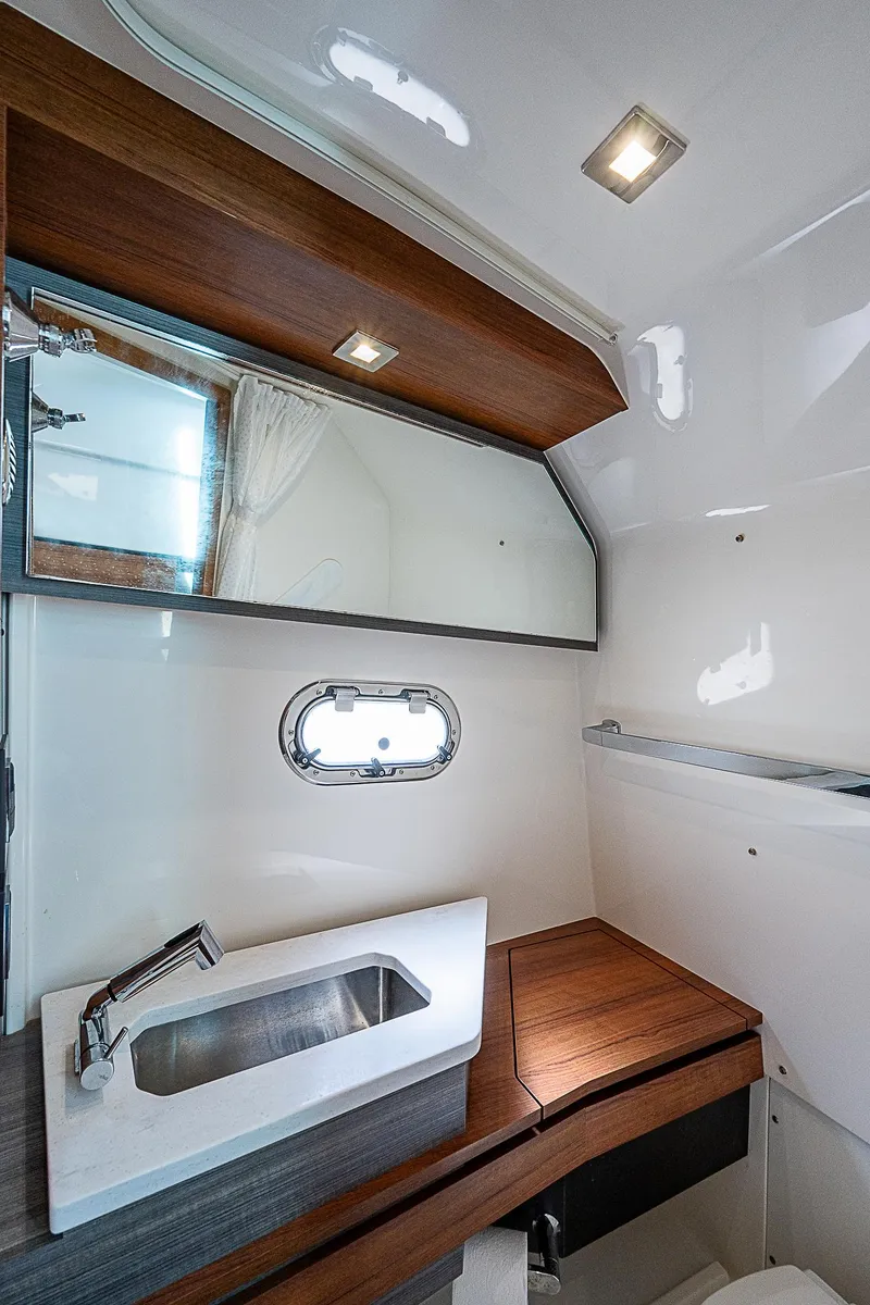 Slide: The Image of Luxurious 2021 Tiara Yachts 34 LS bathroom with modern fixtures and wood accents. - 21