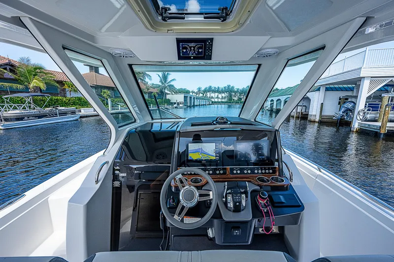 Slide: The Image of Interior view of 2021 Tiara Yachts 34 LS, featuring modern navigation equipment. - 22