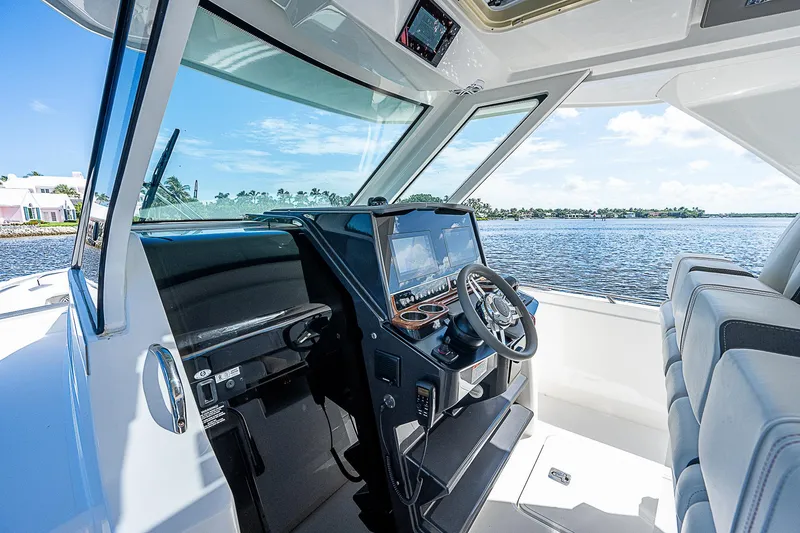 Slide: The Image of Interior of 2021 Tiara Yachts 34 LS, featuring modern helm and scenic water view. - 23