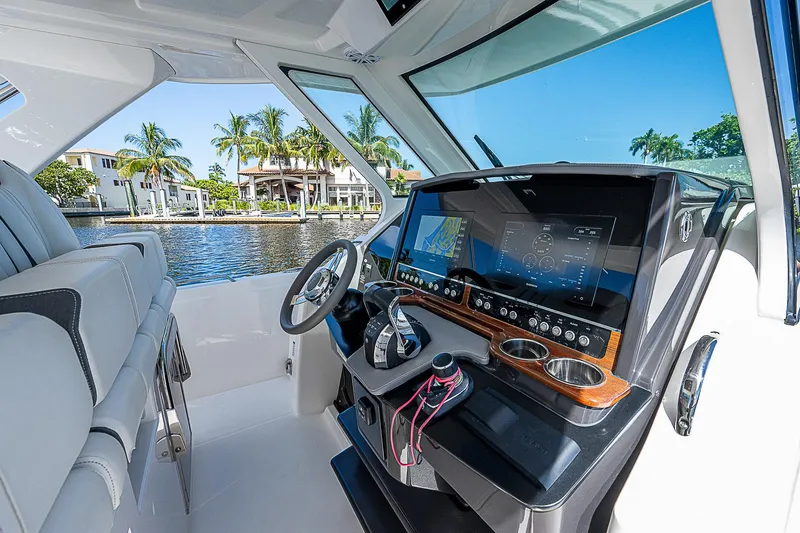 Slide: The Image of 2021 Tiara Yachts 34 LS helm with modern controls and waterfront view. - 24