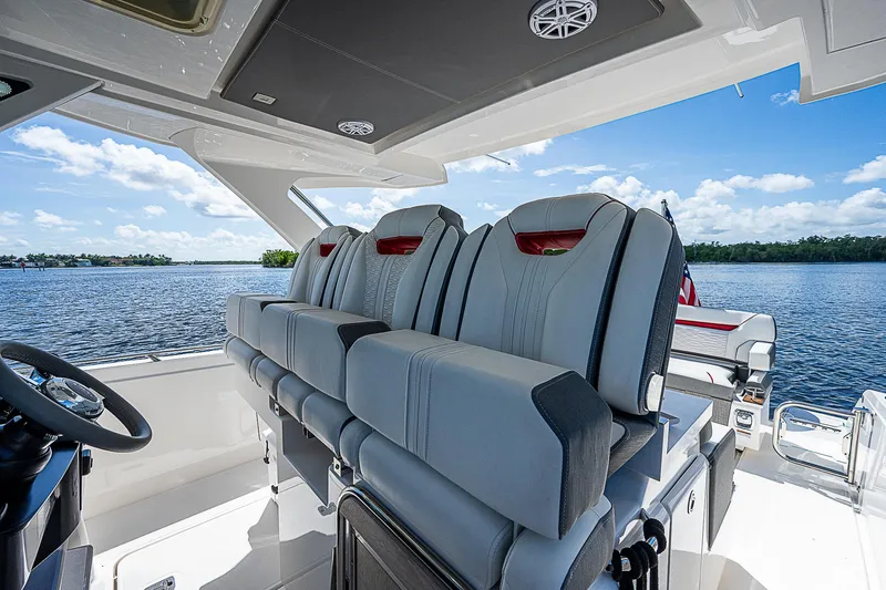 Slide: The Image of Interior of 2021 Tiara Yachts 34 LS, featuring luxurious seating and scenic water view. - 25