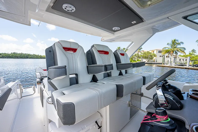 Slide: The Image of 2021 Tiara Yachts 34 LS interior with luxurious seating and scenic waterfront view. - 26