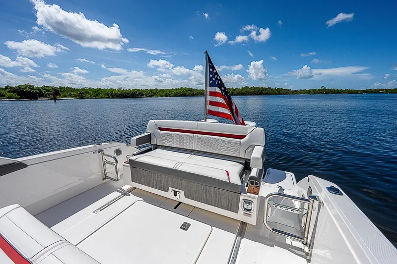 Slide: The Image of 2021 Tiara Yachts 34 LS on serene lake with American flag. - 27