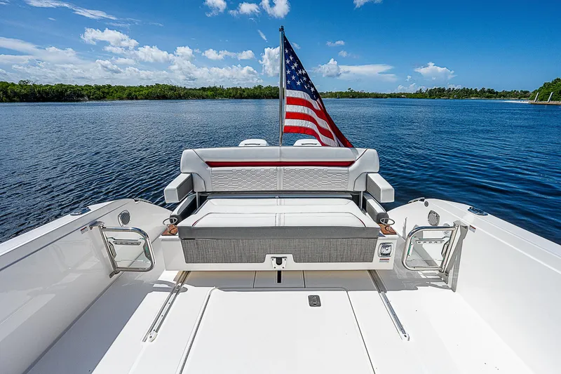 Slide: The Image of 2021 Tiara Yachts 34 LS with American flag on serene water. - 29