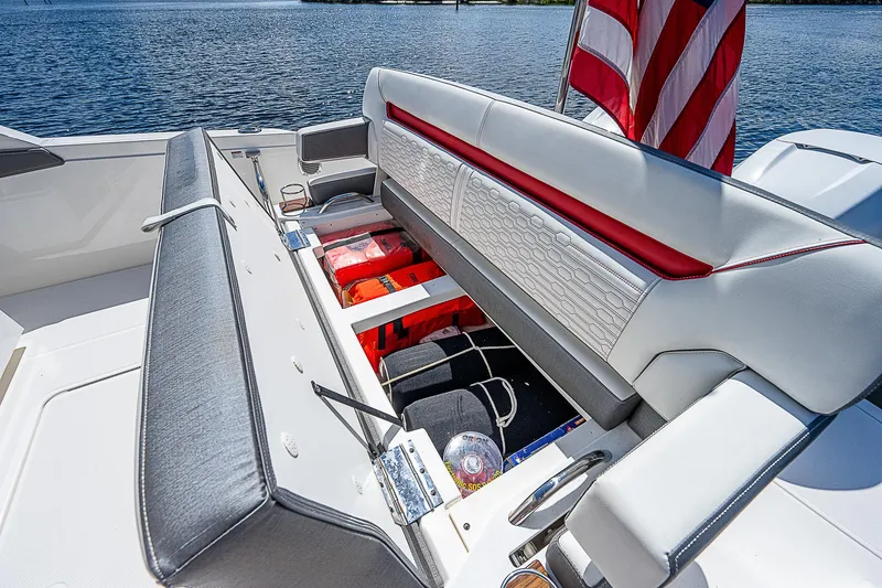 Slide: The Image of 2021 Tiara Yachts 34 LS boat seat storage with American flag. - 30