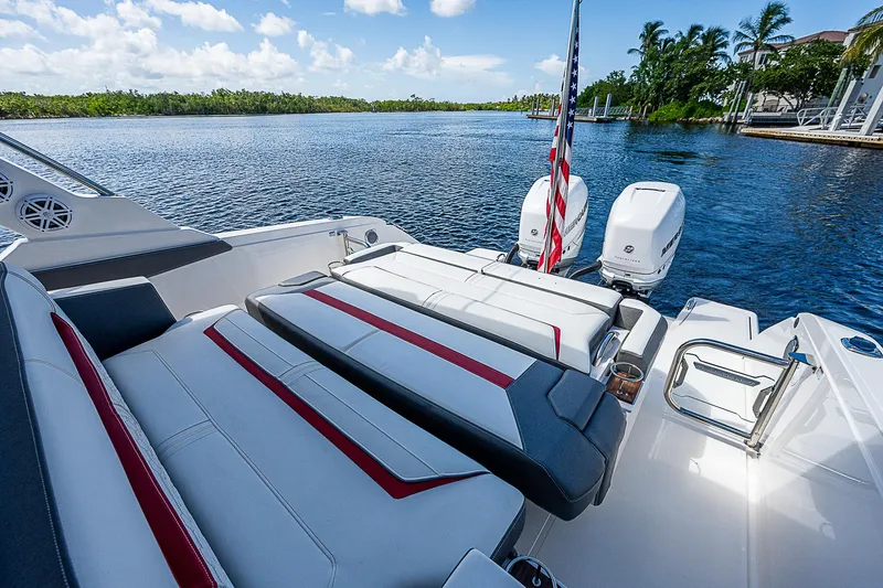 Slide: The Image of 2021 Tiara Yachts 34 LS with luxurious seating, docked by a scenic waterfront. - 34