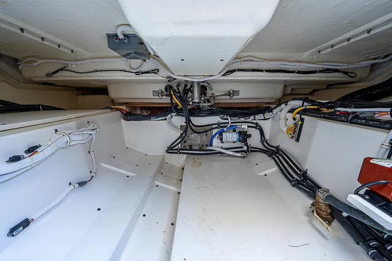 Slide: The Image of Engine compartment of 2021 Tiara Yachts 34 LS, showcasing wiring and mechanical components. - 38