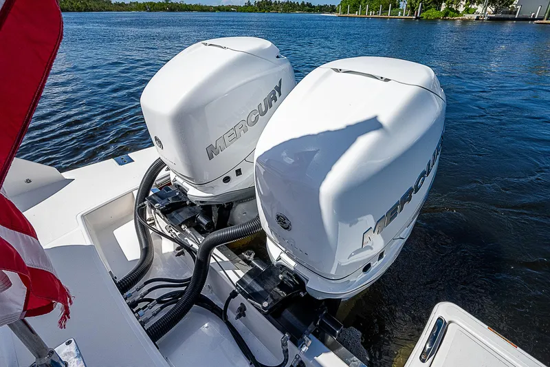 Slide: The Image of 2021 Tiara Yachts 34 LS with dual Mercury outboard engines on a serene lake. - 39
