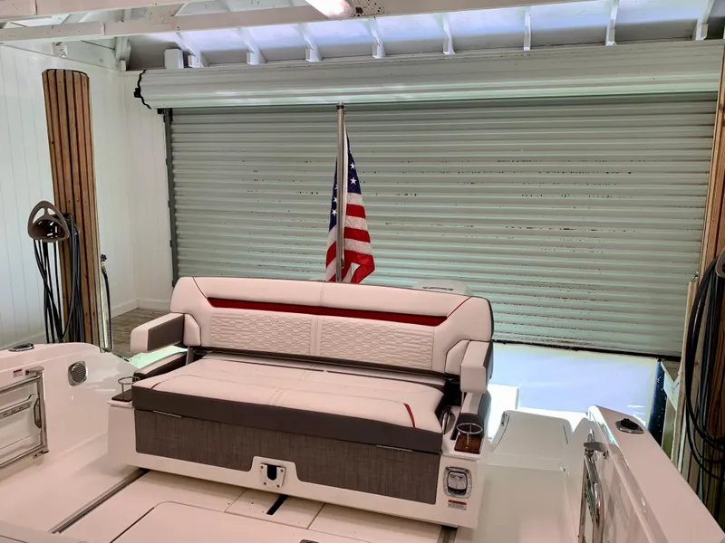 Slide: The Image of 2021 Tiara Yachts 34 LS interior with American flag and seating in a garage. - 43