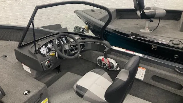 Slide: The Image of 2025 Crestliner 1650 Hawk boat interior with steering console and seating. - 6