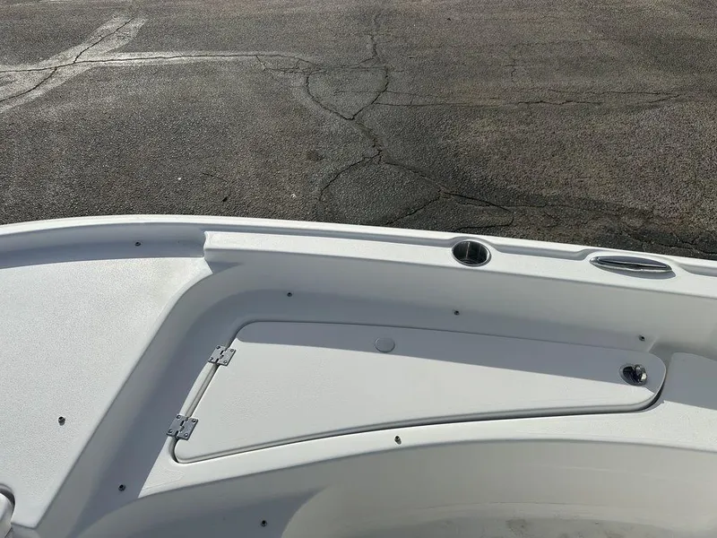 Slide: The Image of 2025 Tidewater 2210 Cb boat deck with storage compartment and cup holder. - 15