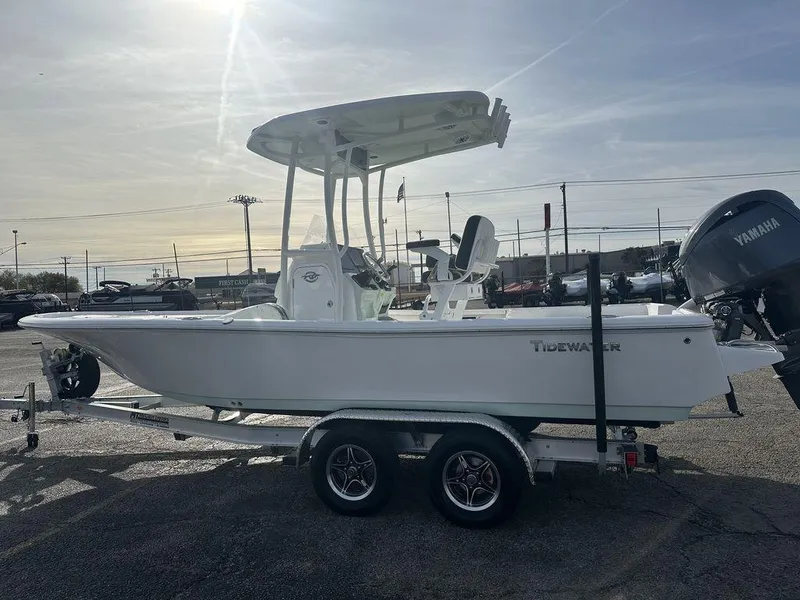 Slide: The Image of 2025 Tidewater 2210 Cb boat on trailer, side view, outdoor setting. - 5