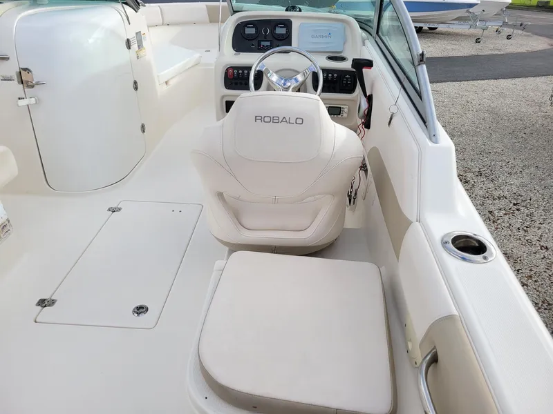 Slide: The Image of 2017 Robalo R227 Dual Console boat interior with steering wheel and seating. - 14