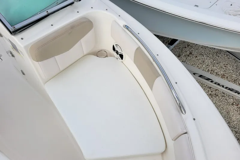 Slide: The Image of 2017 Robalo R227 Dual Console boat interior with cushioned seating and cup holder. - 16