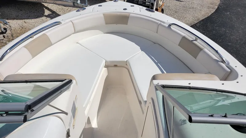 Slide: The Image of 2017 Robalo R227 Dual Console boat interior with spacious seating and windshield. - 17
