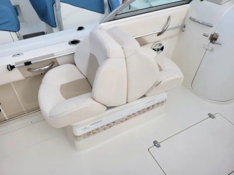 Slide: The Image of 2017 Robalo R227 Dual Console boat interior with white seating and sleek design. - 5