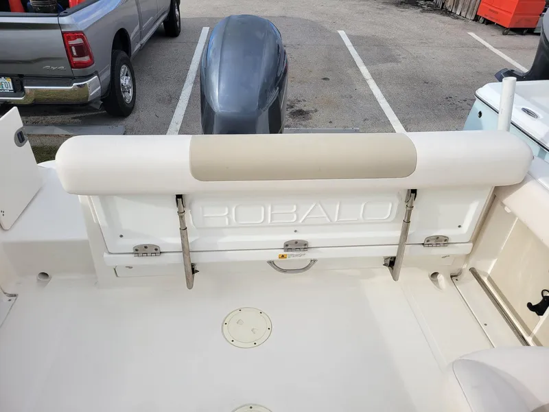 Slide: The Image of 2017 Robalo R227 Dual Console boat interior with seating and motor view. - 7