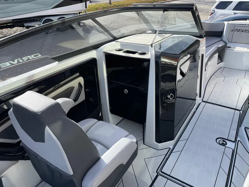 Slide: The Image of 2025 Yamaha Boats 255XD interior with sleek seating and modern dashboard design. - 10