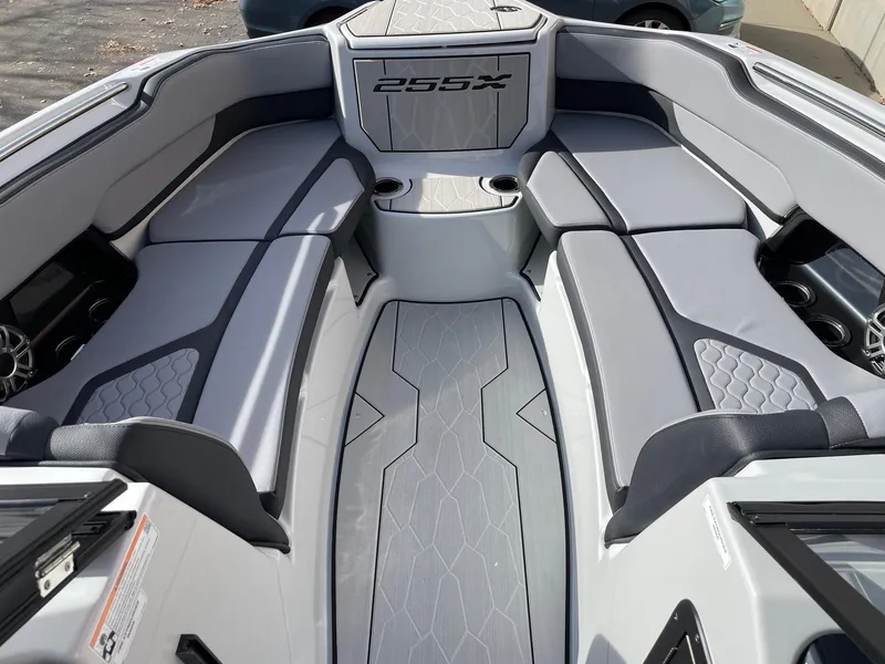 Slide: The Image of 2025 Yamaha Boats 255XD interior with sleek gray seating and modern design. - 11