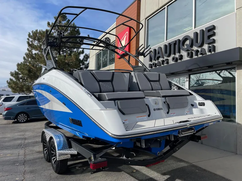 Slide: The Image of 2025 Yamaha Boats 255XD displayed outside dealership, featuring sleek design and vibrant blue accents. - 3