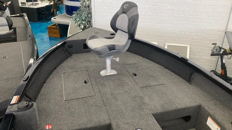 Slide: The Image of 2025 Crestliner 1650 Pro Tiller boat interior with swivel seat and storage compartments. - 3