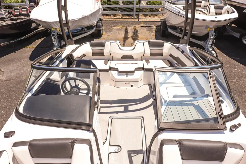 Slide: The Image of 2025 Yamaha Boats AR195 interior with sleek seating and modern dashboard design. - 16